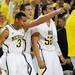 Michigan sophomore Trey Burke, freshman Mitch McGary and junior Jordan Morgan react to a dunk by Glenn Robinson III in the second half at Crisler Center on Sunday, Jan. 6. Michigan beat Iowa 95-67 in the Big Ten home opener. Melanie Maxwell I AnnArbor.com